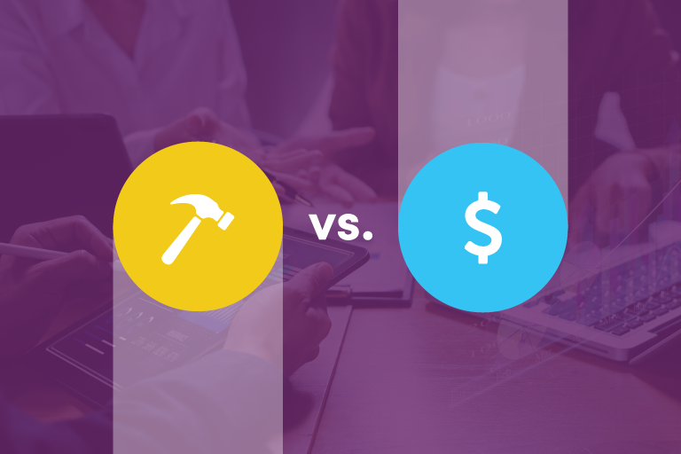 On the lefthand side is a vertical node with yellow circle has a white hammer in the center of the circle. On the left is a vertical node with blue end circle with a white dollar sign in the middle. there is a "vs." in between the nodes. The background is an image of hands working at a desk with a dark purple transparent overlay.