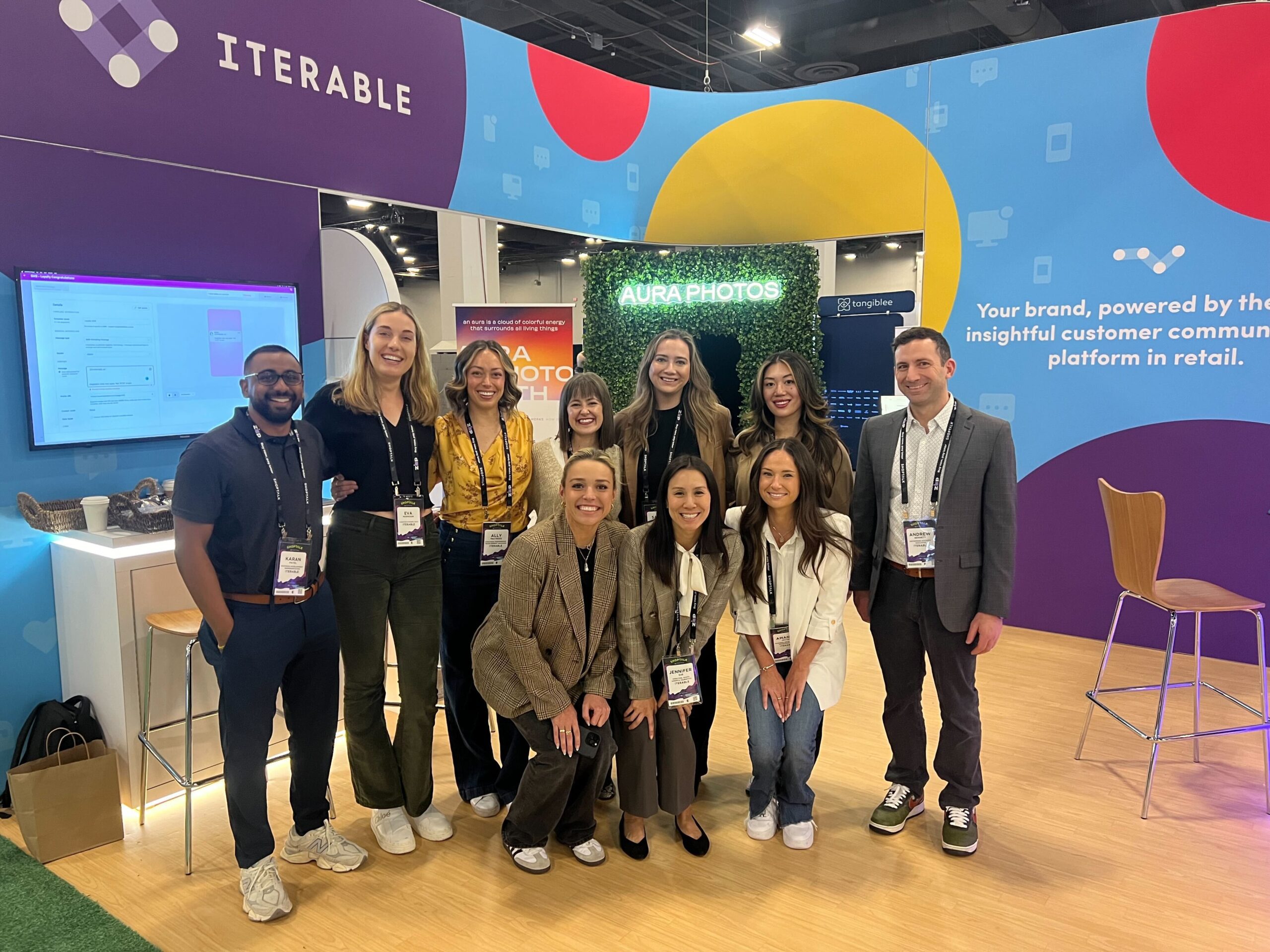 Group photo of the Iterable team at Shoptalk standing at the Iterable booth.