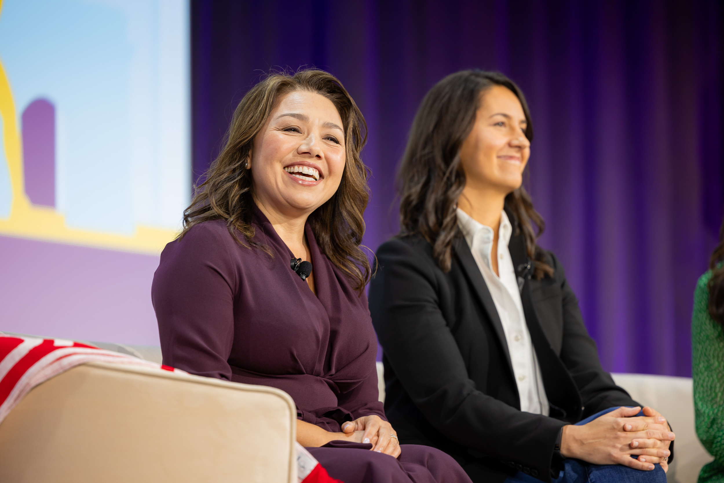A photo of Lena Waters sitting next to Hannah Pscheid on a couch during the Activate keynote.